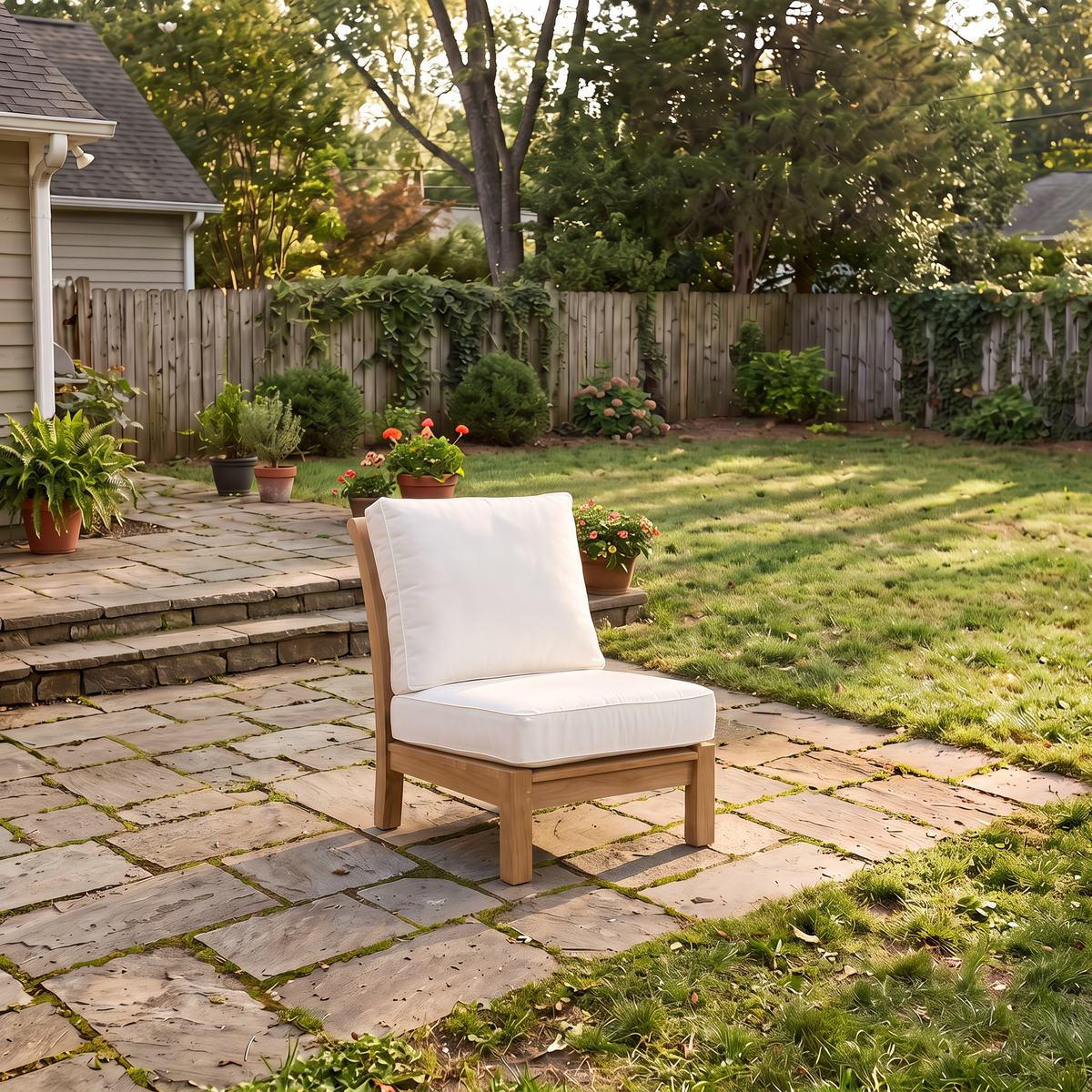 Kingsley Bate Chelsea teak sectional armless chair with white cushions on a backyard patio