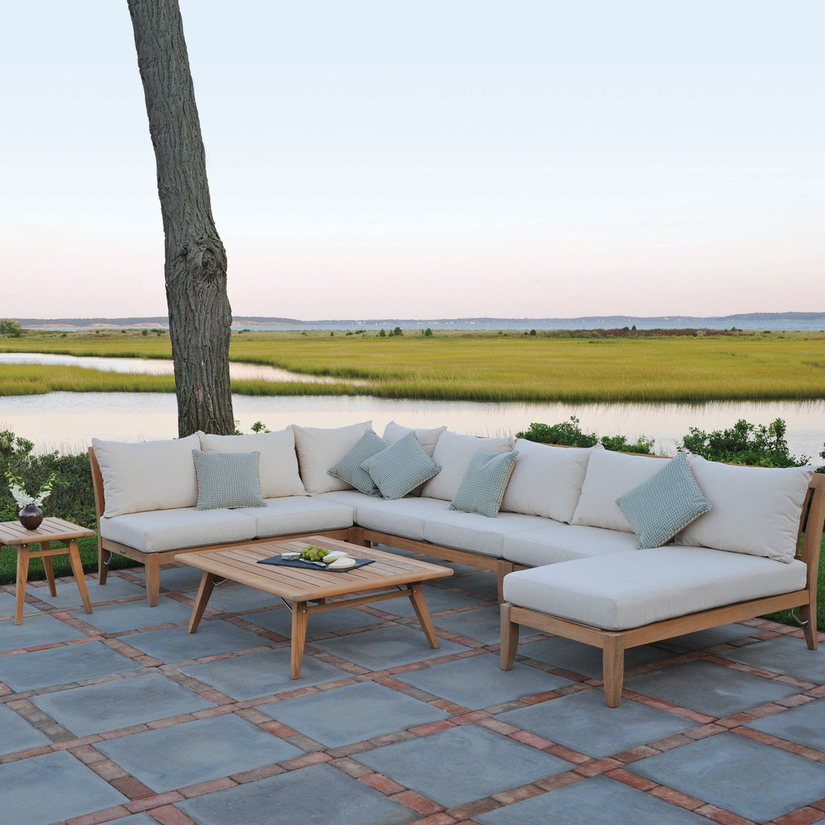 Kingsley Bate Ipanema teak L-shaped sectional on a waterfront patio