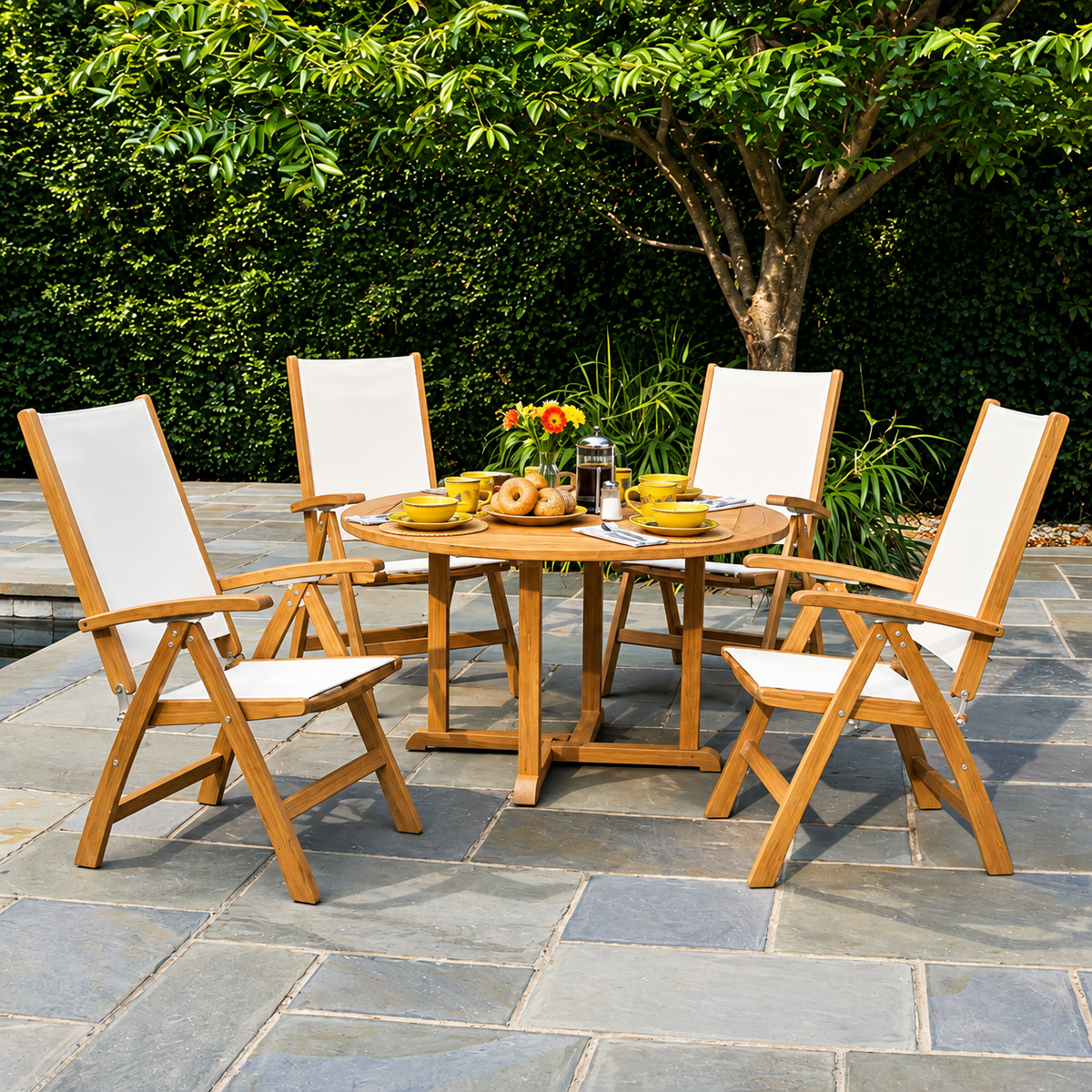 Kingsley Bate St. Tropez armchairs with white slings around an Essex teak round table