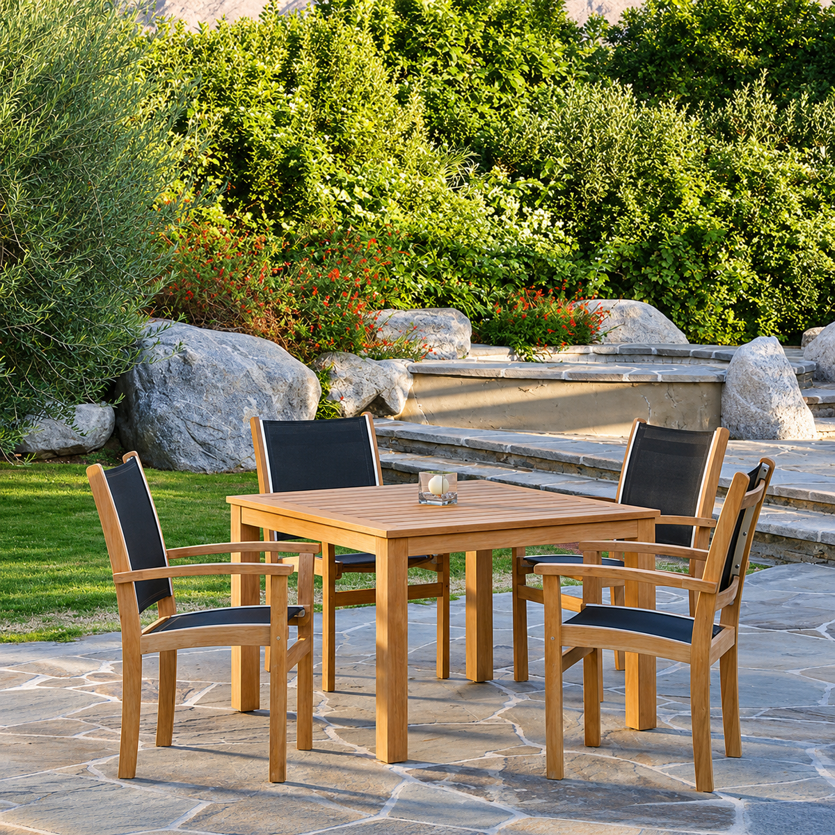 Kingsley Bate St. Tropez sling armchairs and a Wainscott teak square table by a garden