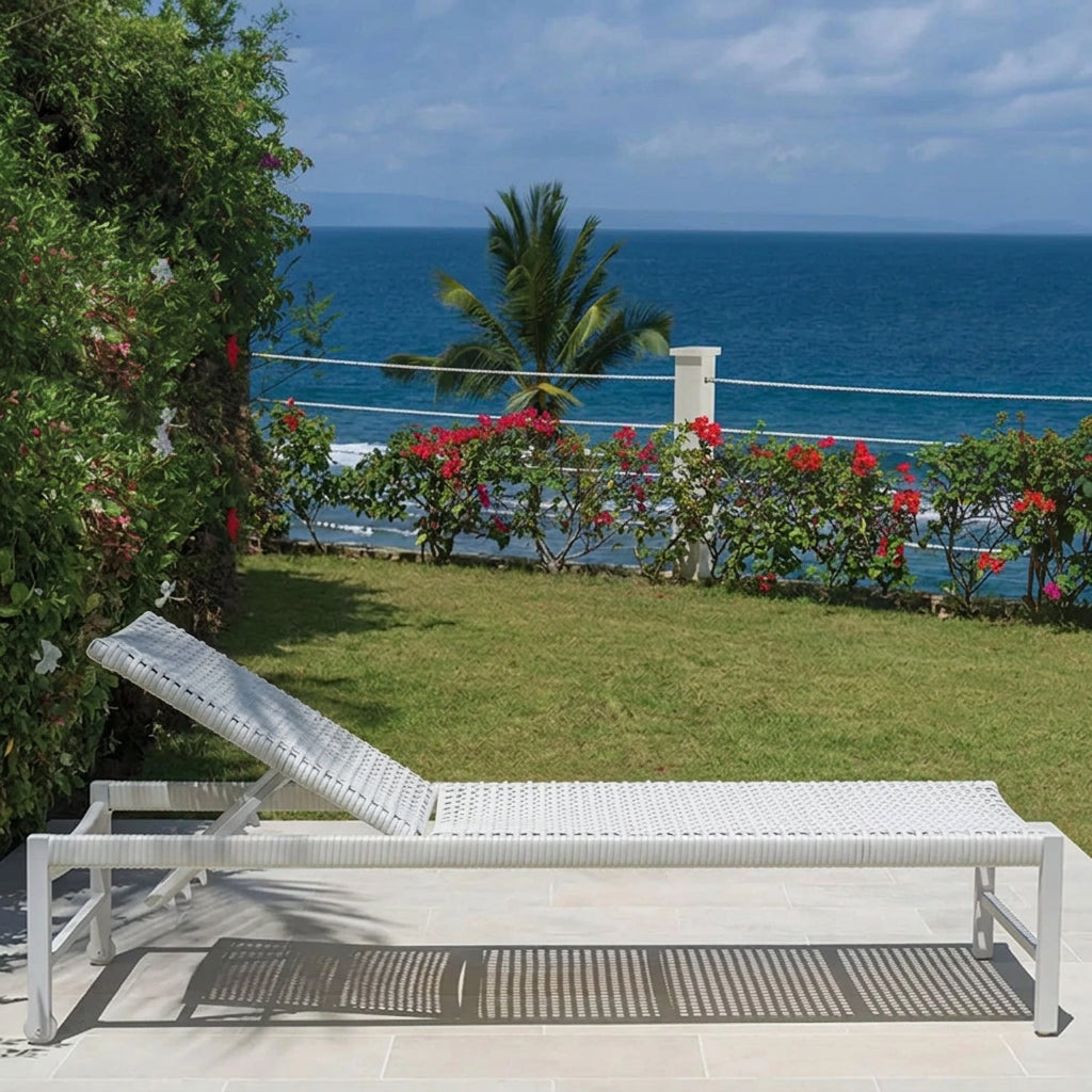 Kingsley Bate Catherine chaise lounge in white on a coastal patio
