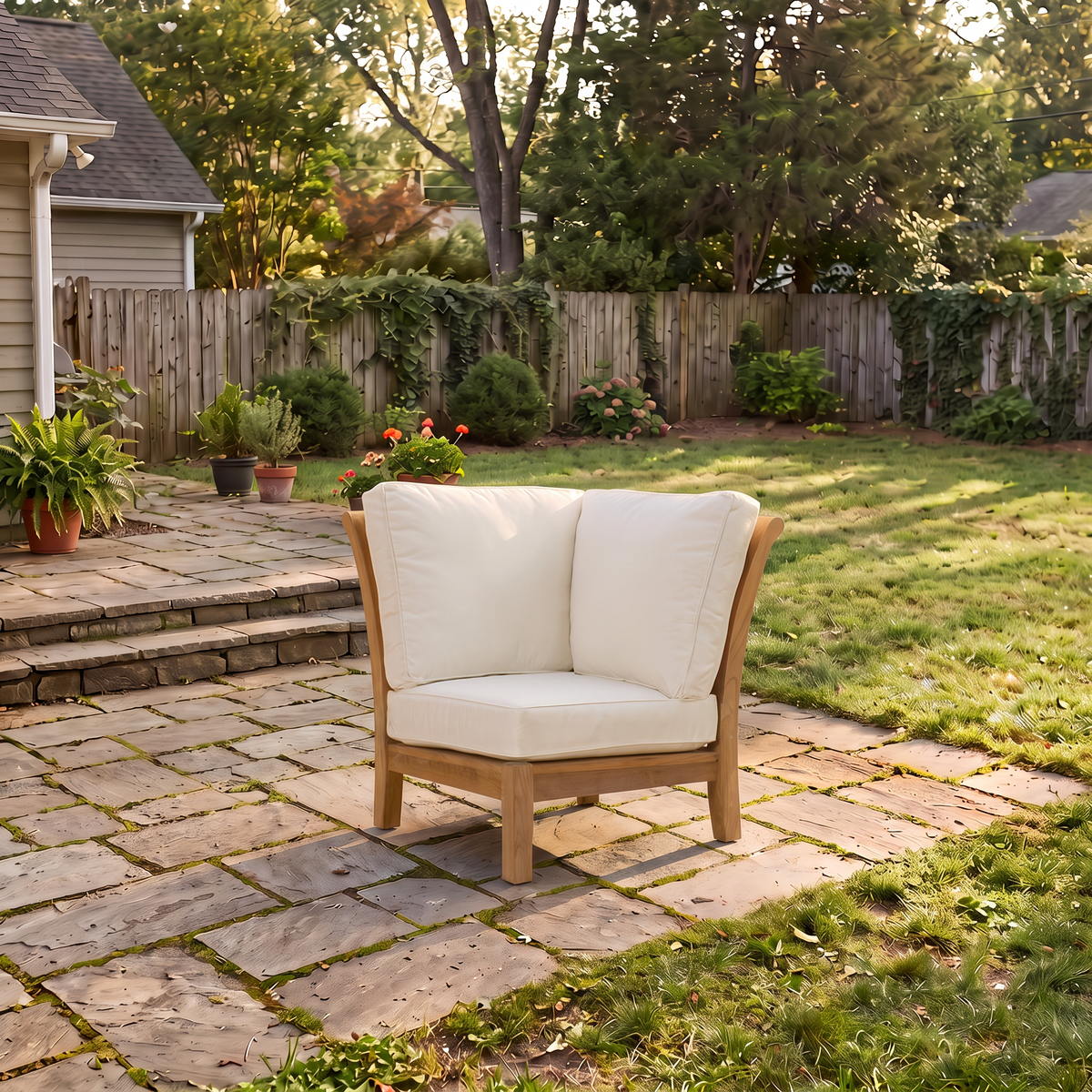 Kingsley Bate Chelsea teak sectional corner chair with white cushions on a backyard patio