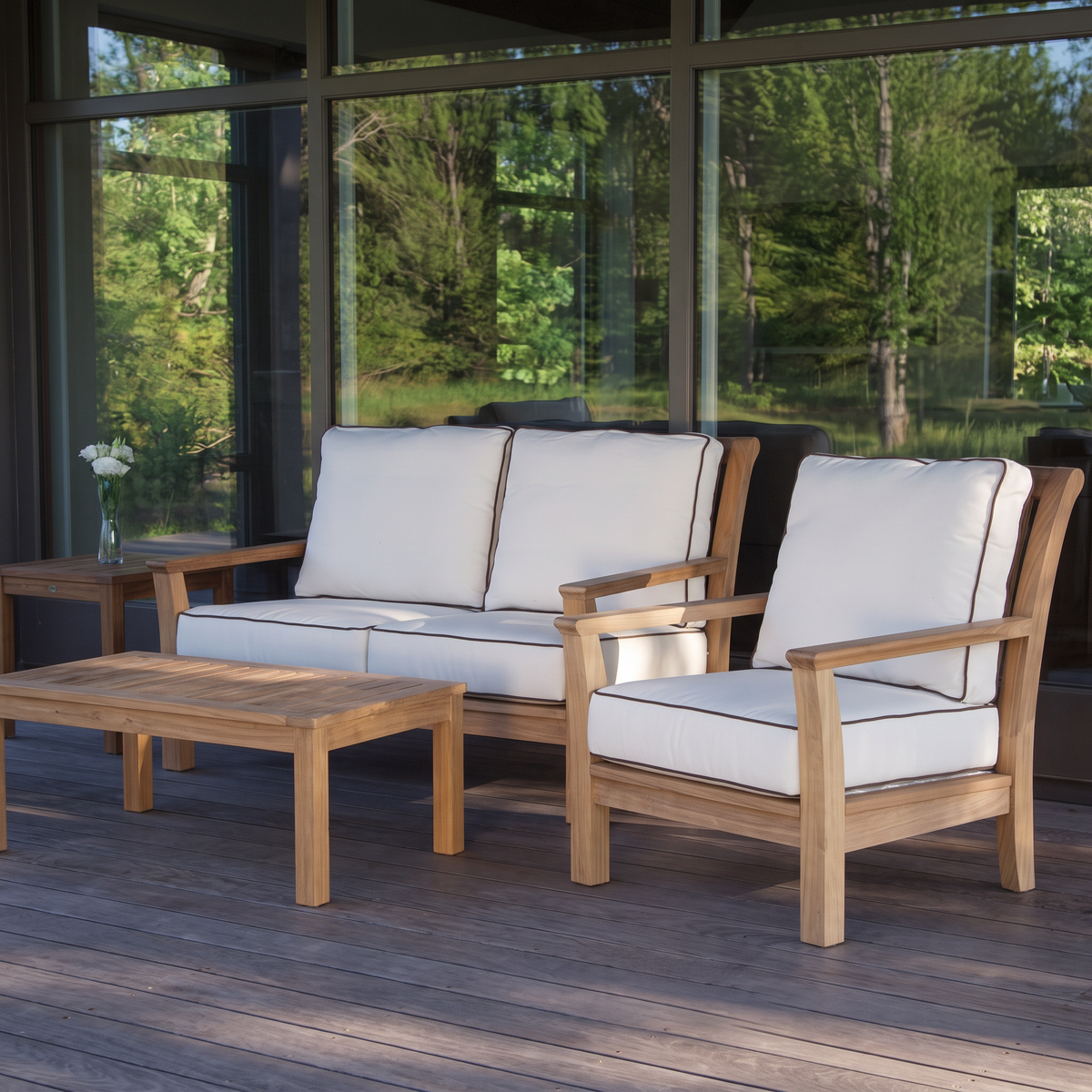 Kingsley Bate Chelsea teak settee and lounge chair on a wood deck