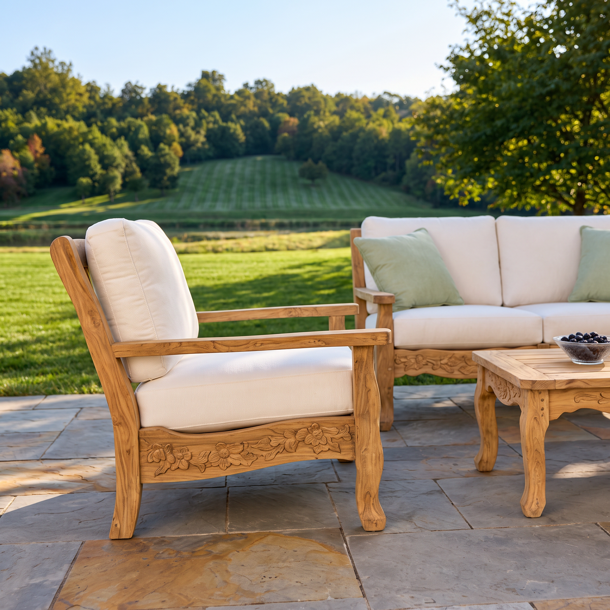 Kingsley Bate Normandy distressed teak lounge chair with white cushions on a patio