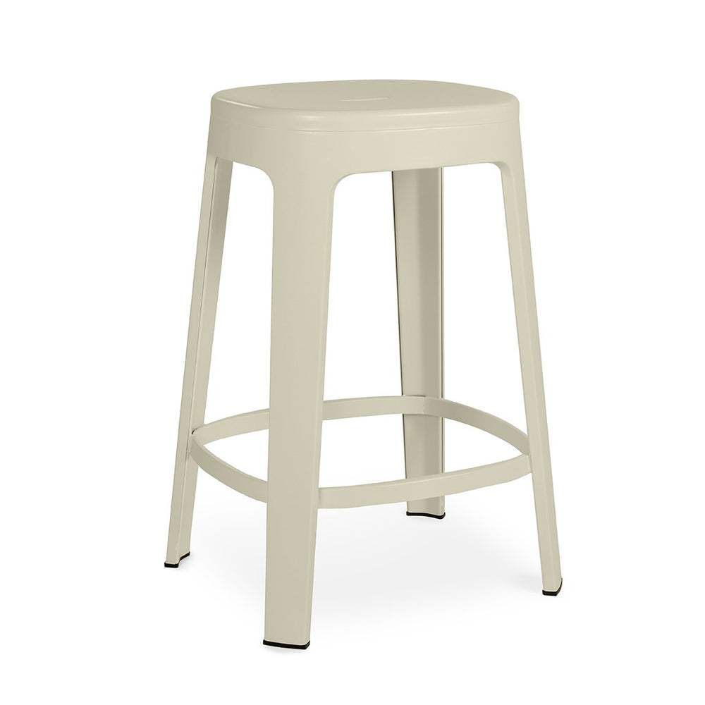 A single white metal stool on a white background