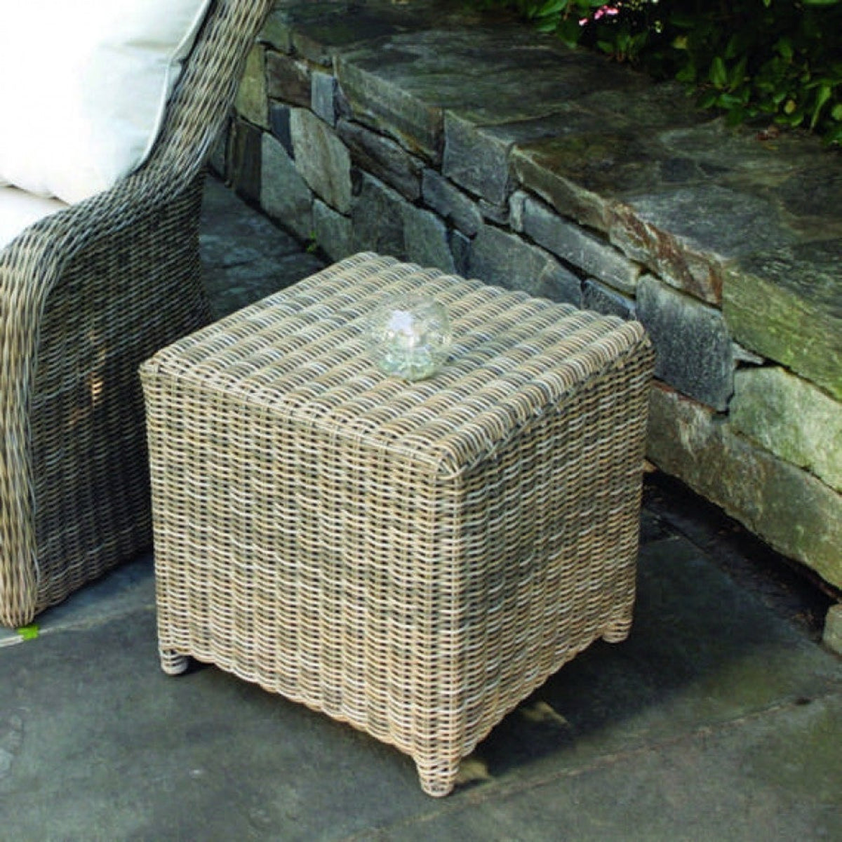 Kingsley Bate Sag Harbor wicker side table / stool on a stone patio
